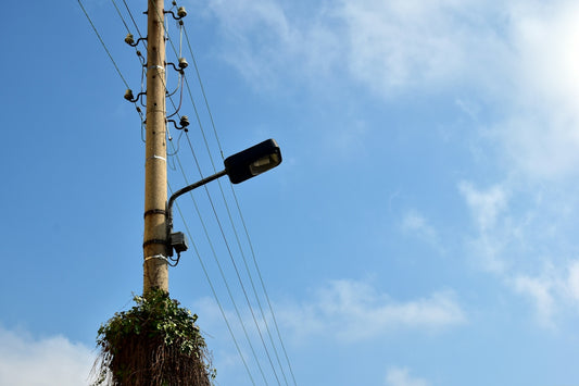 a street light on a pole with a sky background